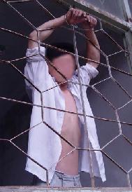 酷刑演示：雙手被吊銬在鐵窗上