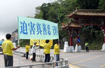 在太魯閣國家公園牌樓前，法輪功學員高舉反迫害橫幅
