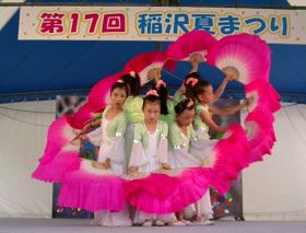 明慧學校的法輪大法小弟子在稻澤市第十七屆夏季活動節舞台上表演扇子舞