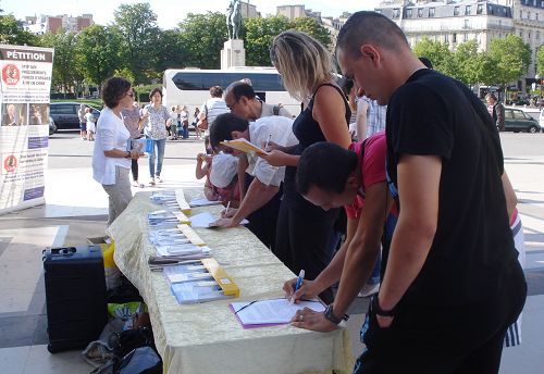 巴黎人權廣場上，人們簽名譴責中共活摘器官