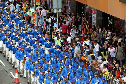 圖7-11：香港法輪功學員二零一四年十月一日舉行遊行，隊伍途經多個鬧市區，吸引不少市民駐足觀看。