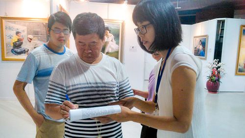 圖說5 6 7 台中市民在「刑事舉報江澤民」聯署書上簽名，希望能共同制止這場對法輪功的迫害。