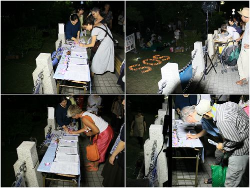 燭光守夜活動中，人們在繼續簽名支持法輪功