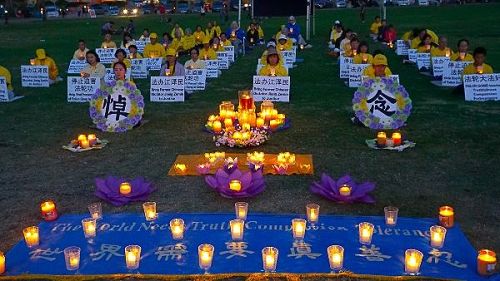 '圖6～7：日落後，法輪功學員們點燃蠟燭，紀念為堅持信仰被迫害致死的同修們'
