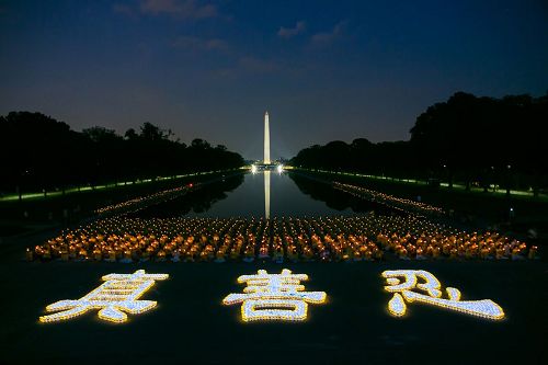 '圖2：在林肯紀念堂與倒影池廣場之間的空地上，數千支蠟燭排成的「真善忍」三個大字，在夜幕中熠熠生輝。'