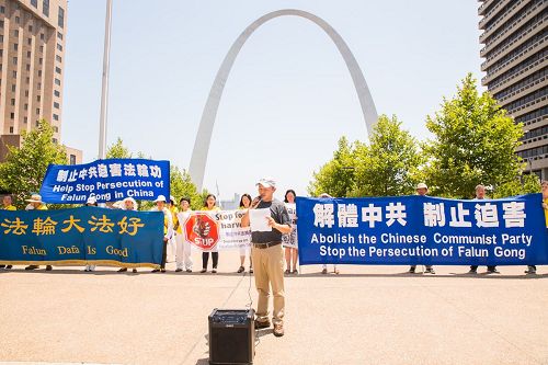 '法輪功學員在密蘇裏州聖路易市中心著名地標大拱門前舉行集會，譴責中共十八年迫害。'