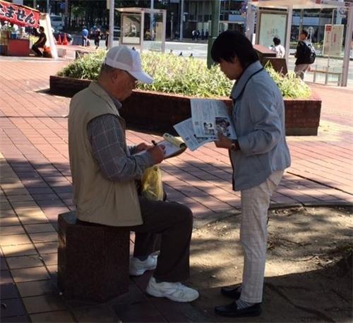 '圖1～3：法輪功學員在名古屋市中心向民眾講真相，徵簽譴責中共迫害。'