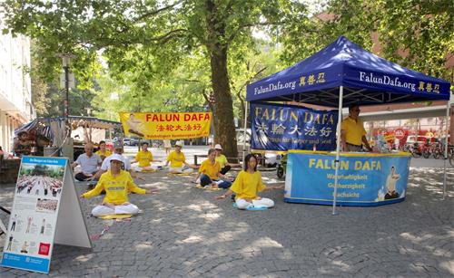 '圖1：二零二零年八月一日，德國法輪功學員在慕尼黑紅十字廣場（Rotkreuzplatz）舉辦了信息日活動。圖為學員在展示功法。'