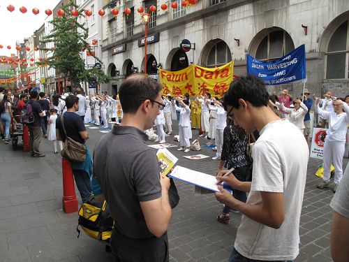 在倫敦唐人街，遊人簽名支持法輪功反迫害