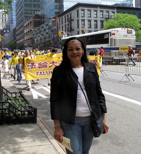 紐約曼哈頓第二大道臨街居民朱莉婭（Julia）站在法輪功學員盛大遊行隊伍前表示支持法輪功