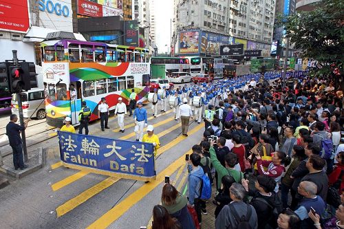 '圖6～7：法輪功學員的遊行吸引遊客及香港市民關注。'