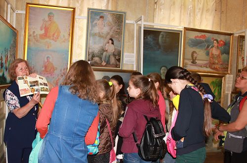 圖1：法輪功學員在烏克蘭哈爾科夫市舉辦「真善忍」國際美展，傳播法輪功真相。圖位，參觀者傾聽畫展導覽的解說。