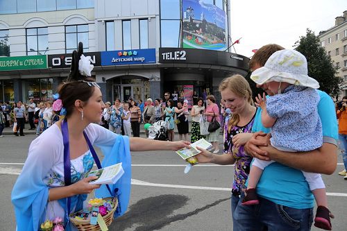 圖6：參加普斯科夫城市日的大遊行活動，法輪功學員沿途派發功法介紹傳單