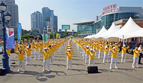 '圖1：上午9點半，在優美、舒緩的煉功音樂聲中，韓國法輪功學員們以展示法輪功功法拉開了活動的序幕。'