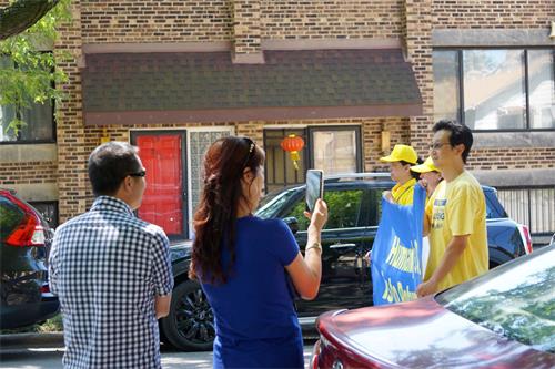 圖6：路旁華裔拍攝法輪功學員的遊行。
