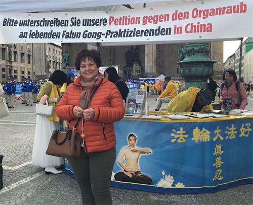 '圖12：奧地利遊客霍伯納（Hubner）女士簽名聲援法輪功學員反迫害。'