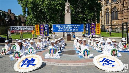 '圖1：二零二一年七月十八日，英國法輪功學員在倫敦議會大廈對面的議會廣場上舉行「七二零」反迫害集會。'
