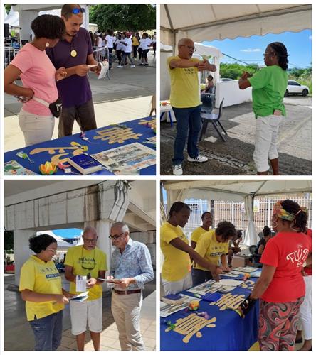 圖1：二零二二年十月十四日至二十三日，加勒比海的法輪功學員在瓜德路普舉辦的「精神健康周」上，向人們介紹法輪功及其真相。有民眾現場學功。