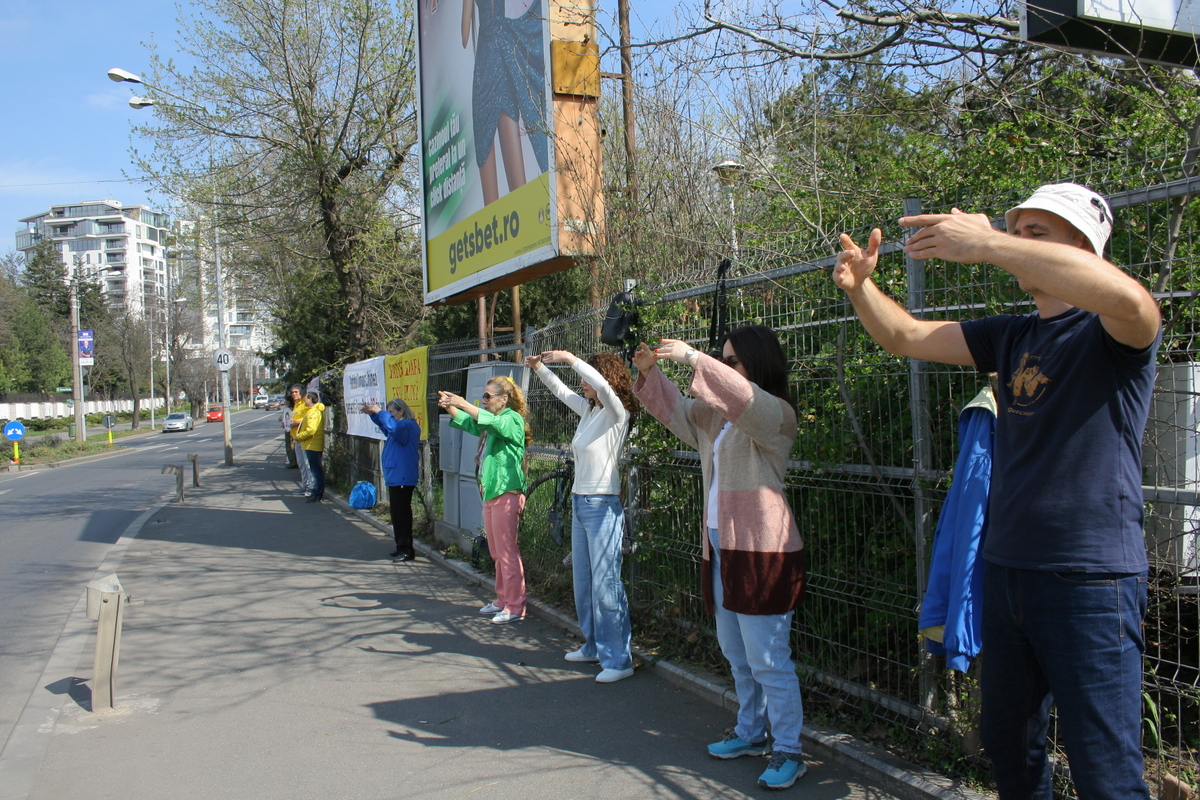 圖3：二零二三年三月二十五日，法輪功學員在布加勒斯特中國大使館前進行和平抗議。圖中學員在展示法輪功功法。